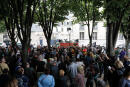 Journalists, union members and supporters gather to ask for the release of the nurse detained for allegedly throwing projectiles at police during a demonstration of healthcare workers the day before and kept in custody, in front of the police headquarters in the 7th arrondissement of Paris on June 17, 2020. - The nurse is summoned to appear before the criminal court on September 25, AFP reports. French police fired tear gas after being pelted with objects during a Paris demonstration on June 16 led by thousands of healthcare workers demanding more investment in the health system. (Photo by FRANCOIS GUILLOT / AFP)