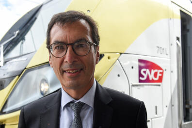 French public rail operator SNCF CEO Jean-Pierre Farandou poses in front of a Omneo Premium Regio 2N train on August 25, 2020, in Orleans, central, France, as part of events marking the Omneo Premium train's maiden voyage. (Photo by JEAN-FRANCOIS MONIER / AFP)