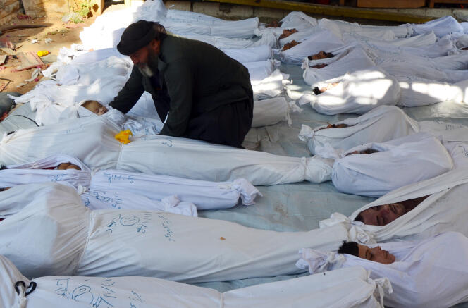 Le 21 août 2013, au lendemain de l’attaque chimique commise dans la ville de Douma. Un homme tient le corps d’une enfant, victime des gaz neurotoxiques.