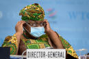 New Director-General of the World Trade Organisation Ngozi Okonjo-Iweala adjustes her facemask as a preventive measure against the Covid-19 coronavirus during a session of the WTO General Council upon her arrival at the WTO headquarters to take office in Geneva, Switzerland, Monday, March 1, 2021. Nigeria's Ngozi Okonjo-Iweala takes the reins of the WTO amid hope she will infuse the beleaguered body with fresh momentum to address towering challenges and a pandemic-fuelled global economic crisis. (Fabrice Coffrini/Pool/Keystone via AP)