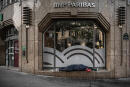 A homeless sleeps at the window of a bank in Paris on April 16, 2020 on the 31th day of a lockdown in France aimed at curbing the spread of the COVID-19 pandemic, caused by the novel coronavirus. (Photo by Philippe LOPEZ / AFP)