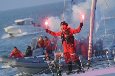 Finnish skipper Ari Huusela celebrates with flares as he crosses the finish line on the 25th and last position of the Vendee Globe round-the-world solo sailing race onboard his boat "Stark" off the coast of Les Sables-d'Olonne, western France, on March 5, 2021. / AFP / LOIC VENANCE 