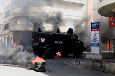 A security forces vehicle drive past burning tyres as supporters of opposition leader Ousmane Sonko, who was arrested following sexual assault accusations, demonstrate in Dakar, Senegal, March 5, 2021. REUTERS/Zohra Bensemra