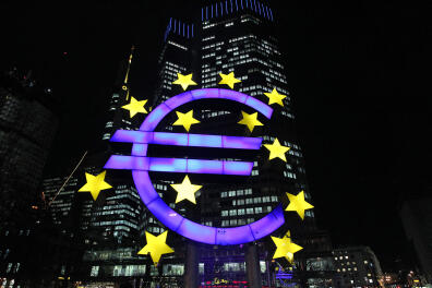 The illuminated sculpture by German artist Ottmar Hoerl's depicting the Euro is seen in front of the European Central Bank, ECB in Frankfurt am Main, western Germany, on January 10, 2013. The euro shot up, gaining 1.5 percent against the dollar, after European Central Bank chief Mario Draghi made upbeat remarks about the eurozone's economic outlook. (Photo by DANIEL ROLAND / AFP)