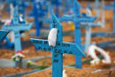 A face mask rests on a cross in an area reserved for the burial of COVID-19 victims at the Nossa Senhora Aparecida cemetery in Manaus, Brazil, on January 5, 2021. (Photo by MICHAEL DANTAS / AFP)
