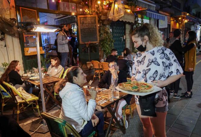 People are having lunch at a restaurant in the Israeli coastal city of Tel Aviv on March 7.