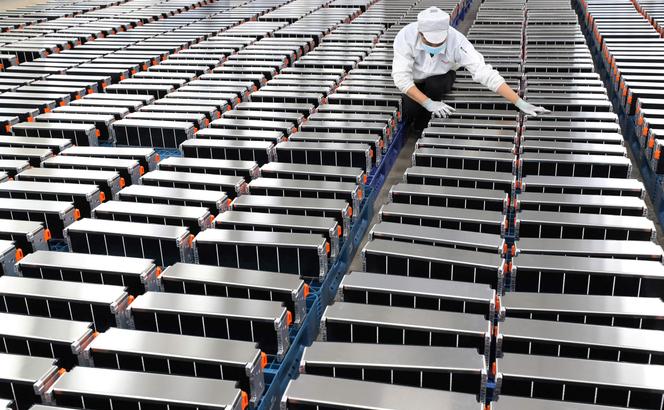 A worker handles car batteries at a battery factory in Nanjing, China, on March 12, 2021.