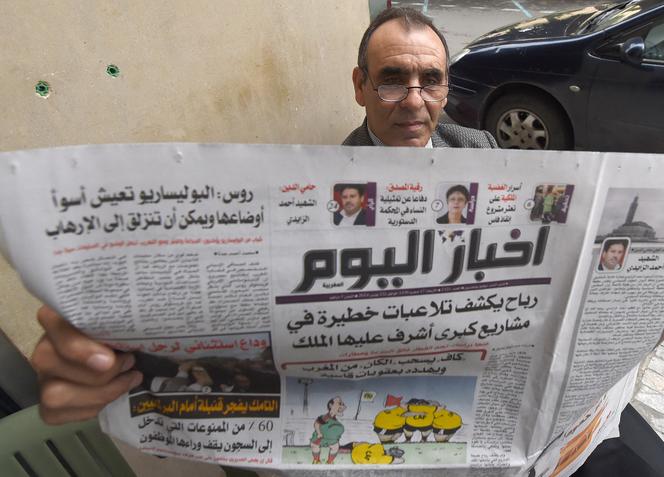 Un homme lit le journal à Rabat, le 12 novembre 2014.