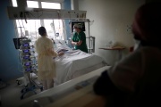 A patient and caregivers in the intensive care unit of the Clinique de l'Estrée, in Stains (Seine-Saint-Denis), on March 18, 2021.