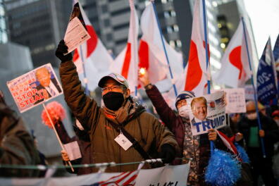 Supporters of U.S. President Donald Trump march ahead of the inauguration of President-elect Joe Biden, amid the coronavirus disease (COVID-19) outbreak, in Tokyo, Japan January 20, 2021. REUTERS/Issei Kato