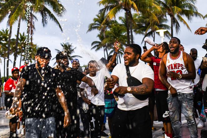 People are dancing and drinking on Ocean Drive in Miami as a curfew rule takes effect on Saturday, March 27 in Florida.