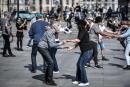 People dance front of the Arab World Institute or Institut du monde arabe in Paris on March 28, 2021, on the second week-end of a new lockdown in France aimed to curb the spread of the Covid-19 cases. / AFP / STEPHANE DE SAKUTIN
