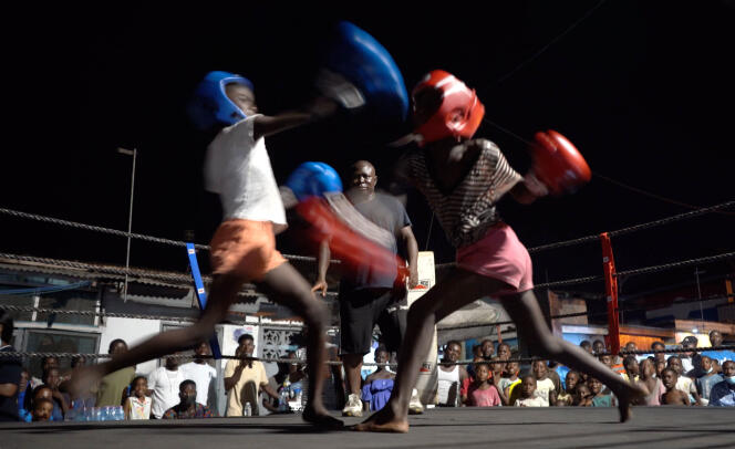 Deux apprenties boxeuses combattent sur un ring ouvert au quartier de Bokum, à Accra, le 20 mars 2021.