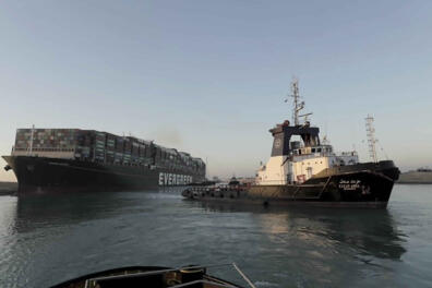 In this photo released by Suez Canal Authority, the Ever Given, a Panama-flagged cargo ship is pulled by one of the Suez Canal tugboats, in the Suez Canal, Egypt, Monday, March 29, 2021. Engineers on Monday "partially refloated " the colossal container ship that continues to block traffic through the Suez Canal, authorities said, without providing further details about when the vessel would be set free. (Suez Canal Authority via AP)