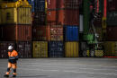 A worker stands in front of containers at Terminal XXI at Sines port on February 12, 2020 in Sines. (Photo by PATRICIA DE MELO MOREIRA / AFP)