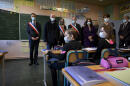 French Education, Youth and Sports Minister Jean-Michel Blanquer (2nd-L) and Lavoncourt's mayor Jean-Paul Carteret (3rd-R) stand in a classroom during a visit at the Lavoncourt education centre, eastern France, as part of the deployment of a nationwide Covid-19 saliva test campaign, on March 1, 2021. (Photo by SEBASTIEN BOZON / AFP)