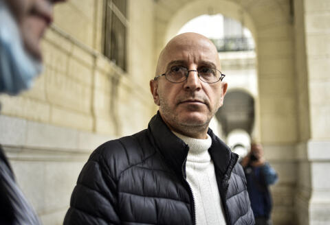 Said Djabelkhir, a renowned Algerian scholar on Islam, looks on outside the Sidi M’hamed courthouse in Algeria's capital Algiers on April 22, 2021. - Djabelkhir, 53, was put on trial after seven lawyers and a fellow academic made complaints against him related to his questioning several hadiths. (Photo by RYAD KRAMDI / AFP)