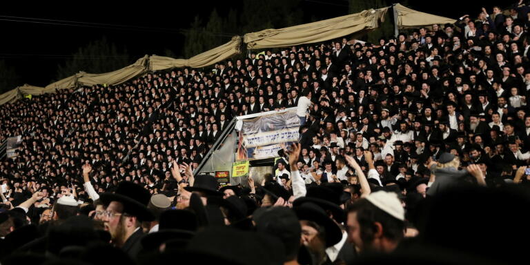 Jewish worshippers sing and dance as they stand on tribunes at the Lag B'Omer event in Mount Meron, northern Israel, April 29, 2021. REUTERS/ Stringer NO RESALES. NO ARCHIVES.     TPX IMAGES OF THE DAY