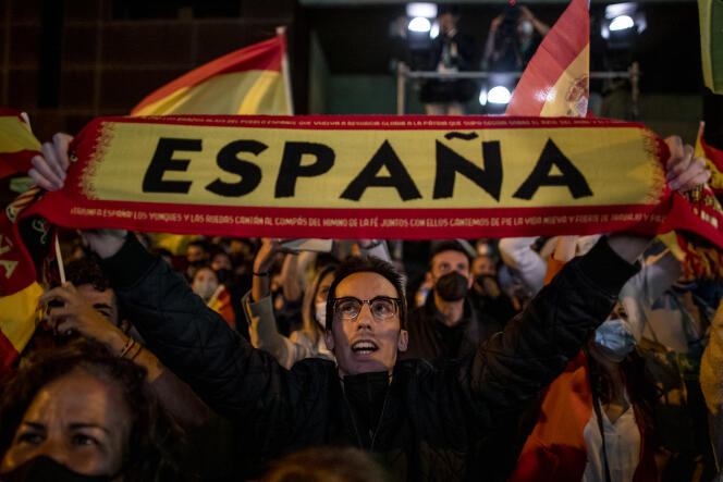 People react outside the Vox party headquarters in Madrid, Spain, Tuesday, May 4, 2021. 