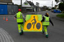 City workers use stencils to mark a bicycle traffic line on a road in Saint-Malo, Brittany, on May 11, 2020, on the first day of the lift lockdown measures set up on March 17 in France to curb the spread of the COVID-19 caused by the novel coronavirus. - People in France were able from today to walk outside without filling in a permit for the first time in nearly eight weeks, teachers will start to return to primary schools, and some shops, including hair salons, will reopen. (Photo by Damien MEYER / AFP)