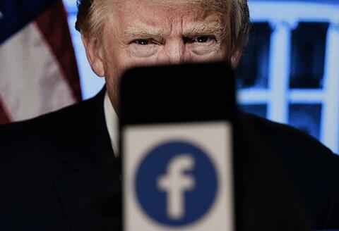 (FILES) In this file photo illustration, a phone screen displays a Facebook logo with the official portrait of former US President Donald Trump on the background, on May 4, 2021, in Arlington, Virginia. Facebook's independent oversight board on May 5, 2021 upheld the platform's ban on former US president Donald Trump but called for a further review of the penalty within six months. The board, whose decisions are binding on the leading social network, said Trump "created an environment where a serious risk of violence was possible" with his comments regarding the January 6 rampage by his supporters at the US Capitol. - / AFP / Olivier DOULIERY 