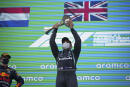 Mercedes driver Lewis Hamilton of Britain lifts his trophy on the podium after winning the Spanish Formula One Grand Prix at the Barcelona Catalunya racetrack in Montmelo, just outside Barcelona, Spain, Sunday, May 9, 2021. At left is second placed Red Bull driver Max Verstappen of the Netherlands. (AP Photo/Emilio Morenatti, Pool)