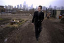 FILE - In this March 4, 2004 file photo, architect Helmut Jahn walks through a vacant lot on Chicago's near north side. Jahn, a prominent German architect who designed an Illinois state government building and worked on the design of the FBI headquarters in Washington, was killed when two vehicles struck the bicycle he was riding outside Chicago. Jahn, 81, was struck Saturday, May 8, 2021, afternoon while riding north on a village street in Campton Hills, about 55 miles (90 kilometers) west of Chicago. (AP Photo/M. Spencer Green File)