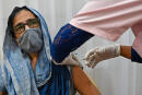 A woman gets inoculated with the Covid-19 coronavirus vaccine at a vaccination center in Mumbai on May 12, 2021. (Photo by Punit PARANJPE / AFP)