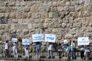 Jewish and Arab activists take part in an event calling for co-existence and an end to violence amid Israel-Gaza fighting, along a section of Jerusalem's Old City walls, May 19, 2021. REUTERS/Ronen Zvulun