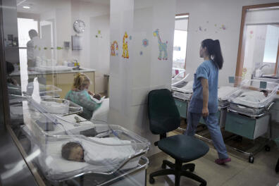 A photo taken on April 12, 2013 shows a nursery of a maternity hospital in Athens. Sunk in recession for the past six years and struggling to steer its economy through painful austerity cuts, Greece now faces a fertility crisis as well. 'Benefits have been cut, the cost of living has risen, wages are down and there is great uncertainty' says Leonidas Papadopoulos, managing director of a hospital and a veteran obstetrician. AFP PHOTO/ LOUISA GOULIAMAKI (Photo by LOUISA GOULIAMAKI / AFP)
