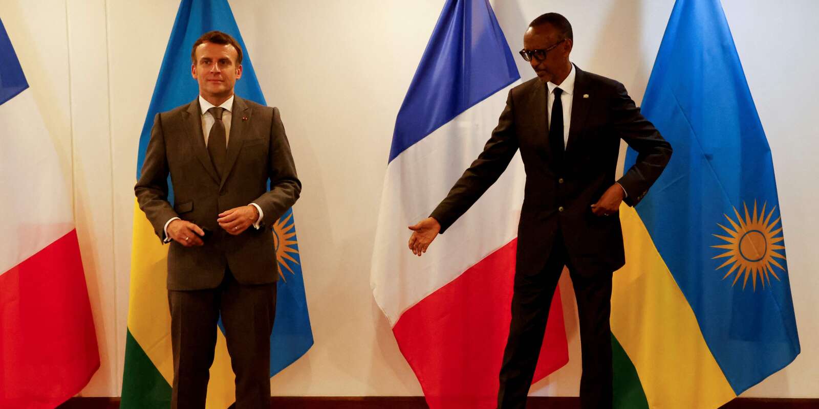 French President Emmanuel Macron and Rwandan President Paul Kagame pose for the photographers after their press conference and prior to their official diner at the Presidential Palace prior to their bilateral meeting in Kigali on May 27, 2021. French President Emmanuel Macron arrived in Rwanda on May 27, 2021, for a highly symbolic visit aimed at moving on from three decades of diplomatic tensions over France's role in the 1994 genocide in the country. Macron is the first French leader since 2010 to visit the East African nation, which has long accused France of complicity in the killing of some 800,000 mostly Tutsi Rwandans. / AFP / Ludovic MARIN
