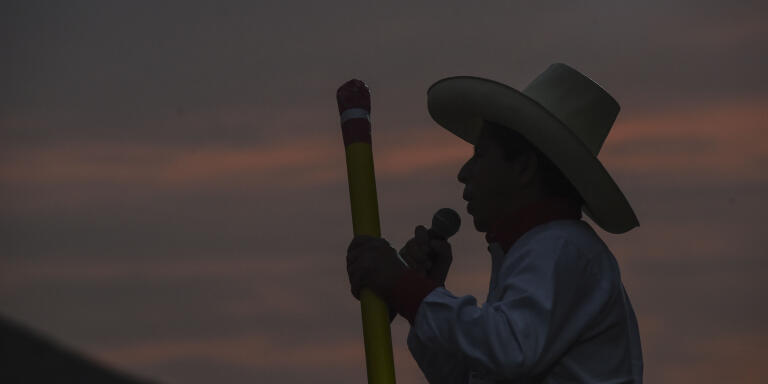 Peruvian left-wing presidential candidate for Peru Libre party, Pedro Castillo, delivers a speech as he holds a big pencil, simbol of the party, during a campaign rally ahead of the runoff election on June 6, east of Lima on May 25, 2021. / AFP / ERNESTO BENAVIDES
