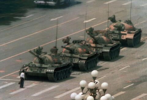 FILE - In this June 5, 1989, file photo, a man stands alone in front of a line of tanks heading east on Beijing's Changan Blvd. in Tiananmen Square, Beijing. Hong Kong’s second ban on an annual vigil for victims of the bloody June 4, 1989, crackdown on Beijing’s Tiananmen Square protest movement and the closure of a museum dedicated to the event may be a further sign that the ruling Communist Party is extending its efforts to erase the event from the collective consciousness from the mainland to Hong Kong. (AP Photo/Jeff Widener, File)