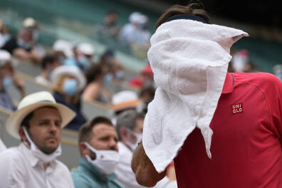 Switzerland's Roger Federer wipes his face during a change of ends as he plays against Croatia's Marin Cilic during their second round match on day 5, of the French Open tennis tournament at Roland Garros in Paris, France, Thursday, June 3, 2021. (AP Photo/Michel Euler)