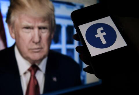 (FILES) In this file photo illustration taken on May 04, 2021, a phone screen displays a Facebook logo with the official portrait of former US President Donald Trump on the background in Arlington, Virginia. Facebook on June 4, 2021, banned former US President Donald Trump for two years, saying he deserved the maximum punishment for violating its rules over a deadly attack by his supporters on the US Capitol. - / AFP / Olivier DOULIERY 