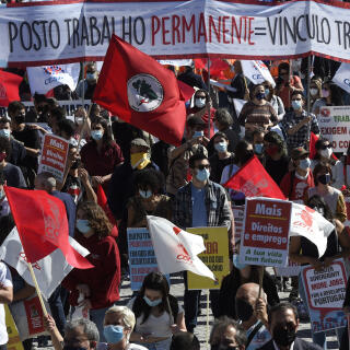 People attend a demonstration called by unions to protest against the Porto Social Summit hosted by the Portuguese presidency of the Council of the European Union, in Porto on May 8, 2021. (Photo by MIGUEL RIOPA / AFP)