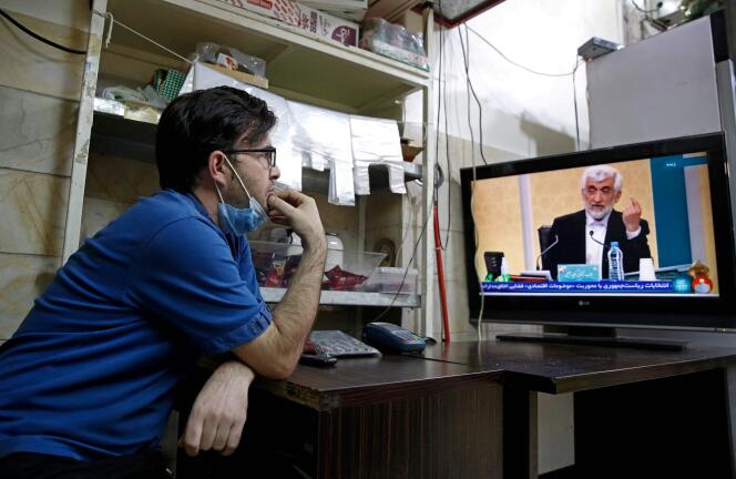 Un Iranien regarde le premier débat télévisé de la campagne présidentielle, samedi 5 juin.