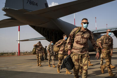 French Barkhane soldiers arriving from Gao, Mali, disembark from a US Air Force C130 cargo plane at Niamey, Niger base Wednesday June 9, 2021, before transferring back to their Bases in France. French President Emmanuel Macron announced at a press conference Thursday June 10, 2021 That operation Barkhane would end and be replaced by support for local partners and counter terrorism. (AP Photo/Jerome Delay)