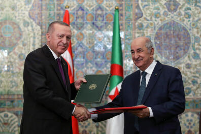 A handout picture taken and released on January 26, 2020 by the Turkish Presidential Press service shows Turkish President Recep Tayyip Erdogan (L) and Algerian President Abdelmadjid Tebboune (R) as they sign bilateral agreements between Turkey and Algeria in a joint press conference following their meeting at the Presidential Office in Algiers. (Photo by Murat KULA / TURKISH PRESIDENTIAL PRESS SERVICE / AFP) / RESTRICTED TO EDITORIAL USE - MANDATORY CREDIT "AFP PHOTO / Murat Kula / TURKISH PRESIDENTIAL PRESS SERVICE " - NO MARKETING - NO ADVERTISING CAMPAIGNS - DISTRIBUTED AS A SERVICE TO CLIENTS