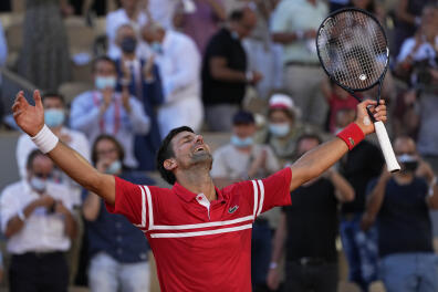Serbia's Novak Djokovic celebrates after defeating Stefanos Tsitsipas of Greece in their final match of the French Open tennis tournament at the Roland Garros stadium Sunday, June 13, 2021 in Paris. (AP Photo/Michel Euler)