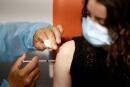FILE PHOTO: A medical worker administers a dose of the "Comirnaty" Pfizer BioNTech COVID-19 vaccine in a vaccination center in Nantes as part of the coronavirus disease (COVID-19) vaccination campaign in France, June 3, 2021. REUTERS/Stephane Mahe/File Photo