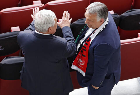 Hungarian Prime Minister Viktor Orban (R) speaks to an unidentified man before the UEFA EURO 2020 Group F football match between Hungary and Portugal at the Puskas Arena in Budapest on June 15, 2021. (Photo by Laszlo Balogh / POOL / AFP)
