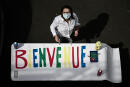 A staff member of the private school Institut Sainte Genevieve prepare a welcoming banner on May 7, 2020, in the French capital Paris as the schools in France are to gradually reopen from May 11, when a partial lifting of restrictions due to the Covid-19 pandemic caused by the novel coronavirus will come into effect. (Photo by PHILIPPE LOPEZ / AFP)