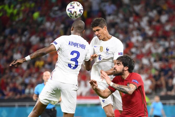 Presnel Kimpembe (left) and Rafael Varane tackle Portuguese midfielder Ruben Neves during the Euro 2020 Group F football match at Puskas Arena in Budapest on June 23, 2021.