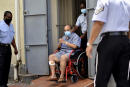 Antigua and Barbuda businessman Mehul Choksi exits in a wheelchair the magistrate's court in Roseau, Dominica, Friday, June 4, 2021. Choksi is wanted in his native India on a string of charges that include corruption, money laundering and criminal conspiracy. The fugitive was arrested May 24 on the neighboring island of Dominica accused of illegal entry. (AP Photo/Clyde Jno Baptiste)