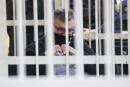 FILES) In this file photo taken on February 17, 2021 opposition politician and banker Viktor Babaryko, charged with corruption and money laundering, is seen from inside a defendants' cage during the opening day of his trial in Minsk. One of Belarus's leading opposition figures on Monday denied any wrongdoing as he addressed the court in a trial that may see him jailed for 15 years on fraud charges. Former banker Viktor Babaryko was arrested in June last year ahead of a disputed presidential election that sparked historic nationwide demonstrations that griped the ex-Soviet country for months. / AFP / BELTA / Oksana MANCHUK 