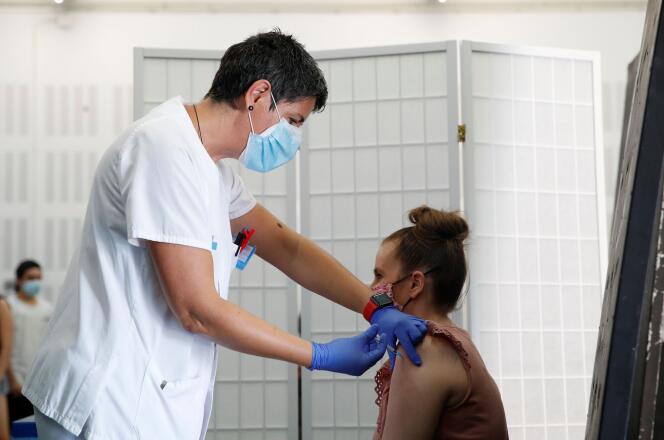A woman receives a vaccine against the coronavirus disease (COVID-19) during a program without appointment in Sant Vicenc de Casteller, north of Barcelona, Spain, July 6, 2021. REUTERS/ Albert Gea