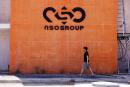 A man walks past the logo of Israeli cyber firm NSO Group at one of its branches in the Arava Desert, southern Israel July 22, 2021. REUTERS/Amir Cohen