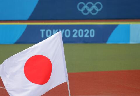 CORRECTION / Japan's national flag is hoisted on the field prior to the Tokyo 2020 Olympic Games softball opening round game between Mexico and Japan at Fukushima Azuma Baseball Stadium in Fukushima, Japan, on July 22, 2021. (Photo by KAZUHIRO FUJIHARA / AFP)