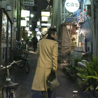 Chiga, owner of the all woman bar 'Gold Finger' walking in the 'Golden Gia' area of Shinjuku, Tokyo.